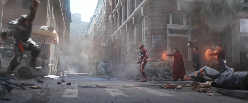 The Avengers stand up against Thanos' minions on a debris filled New York street.