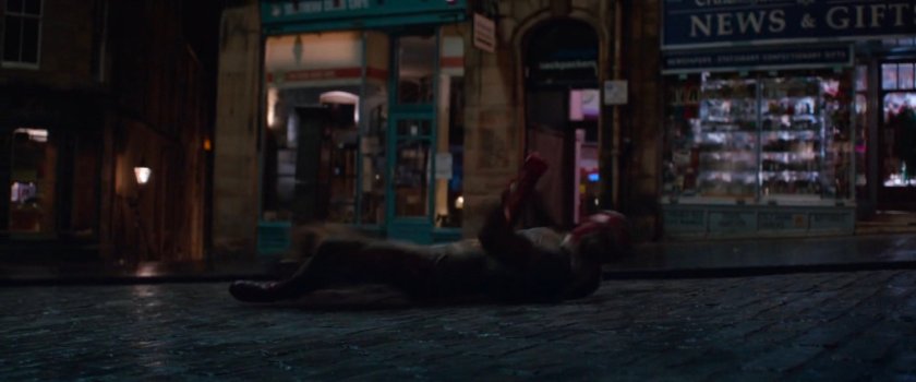 Vision lying the middle of a cobblestone street.