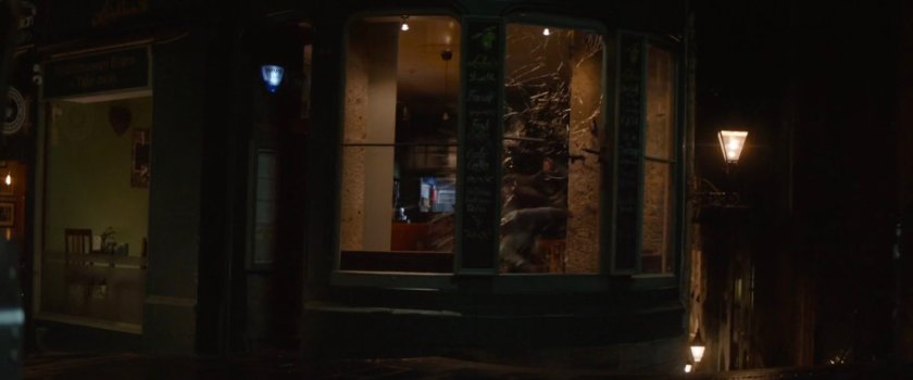 The front of a shop window being broken.