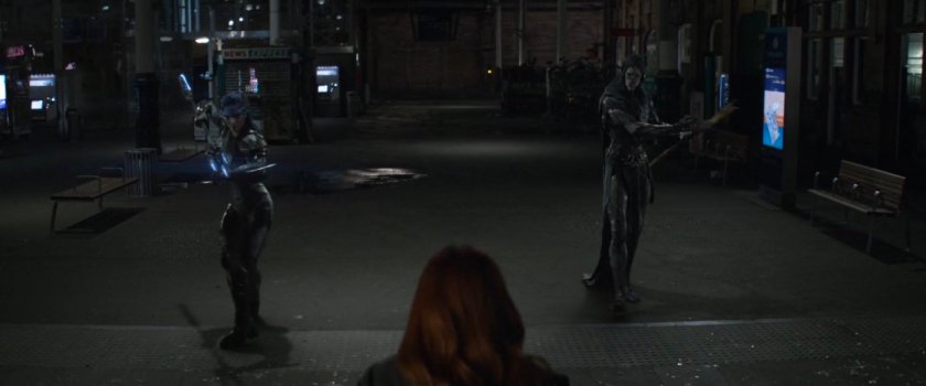 Proxima Midnight and Corvus Glaive stadning in train station.