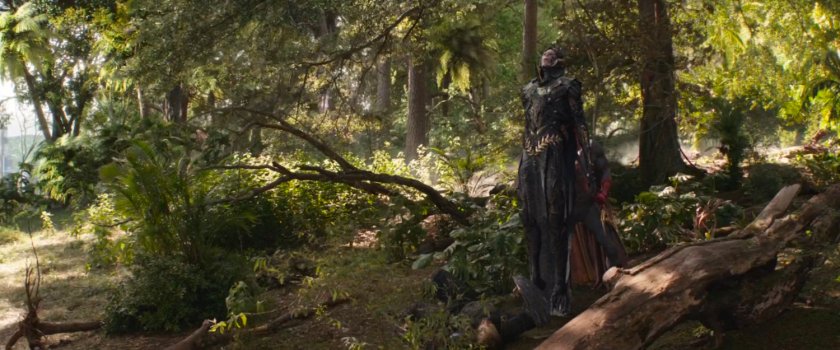 Vision stabbing Corvus Glaive in a forest.
