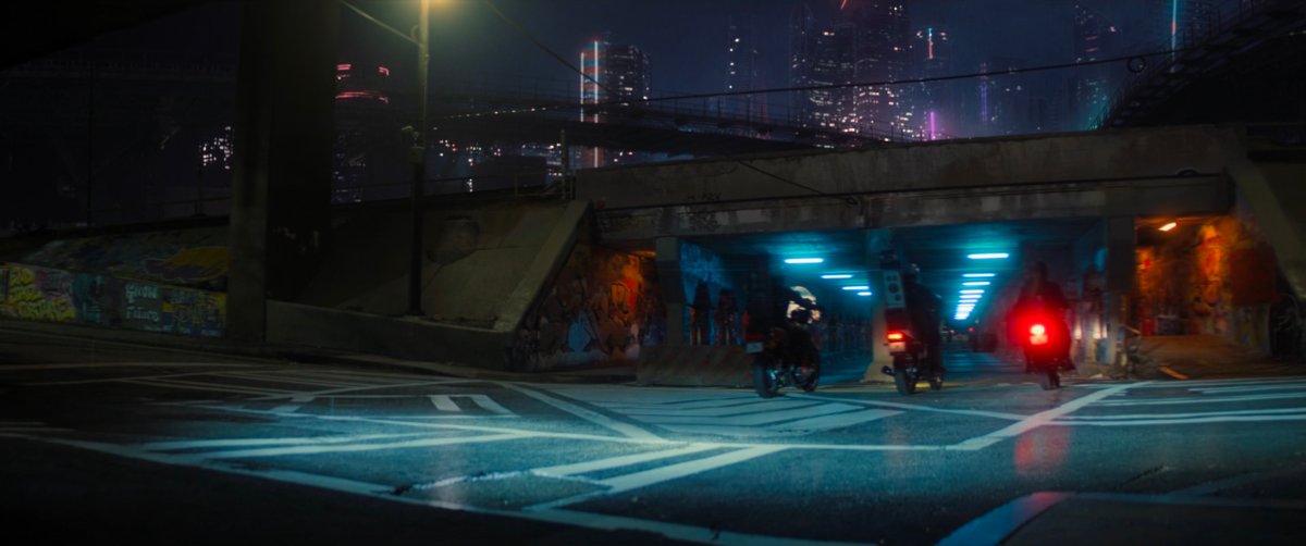 Motorcycles drive into a tunnel in Madripoor.