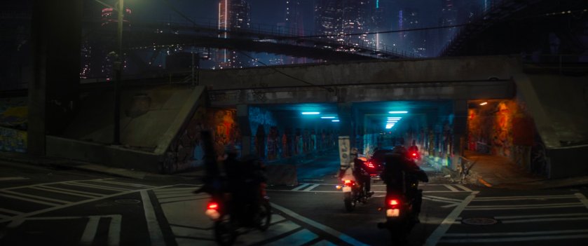 Motorcycles drive into a tunnel in Madripoor.