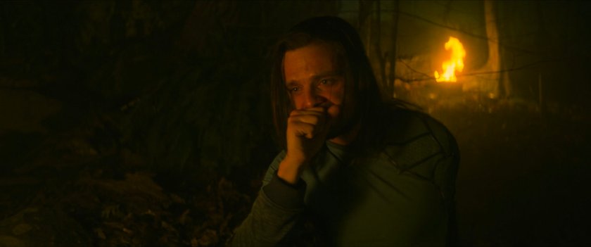 Bucky in a dark, torch-lit Wakandan plateau.