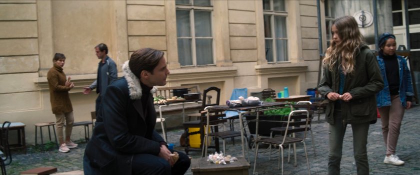 Zemo and a young girl in courtyard of GRC Resettlement Camp.
