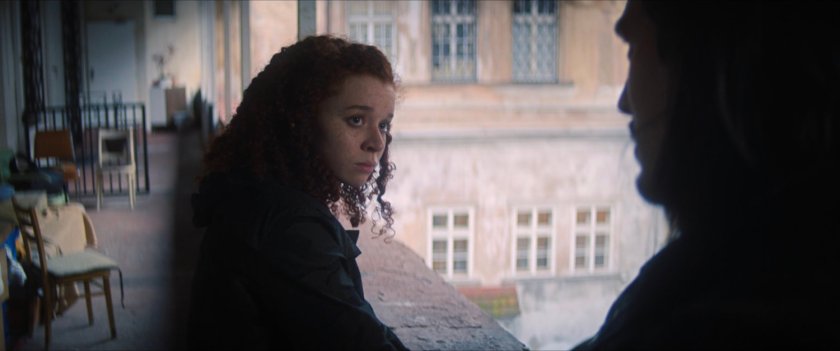Karli on a balcony in a Latvian courtyard.