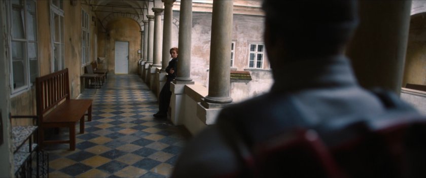 Sam and Karli on a balcony in a Latvian courtyard.