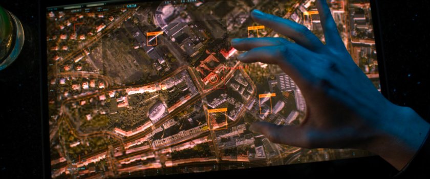 Hand over screen with satellite image of Flag Smasher headquarters.