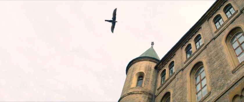 The Falcon flying above Flag Smasher headquarters.
