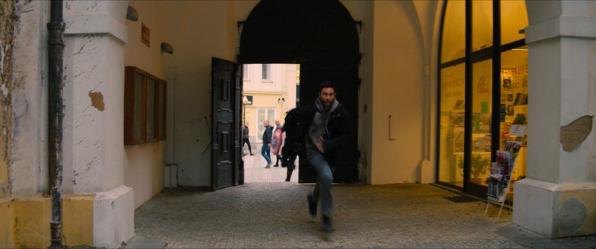 Nico runs into Latvian courtyard.