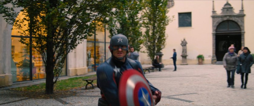 John Walker runs into Latvian courtyard.