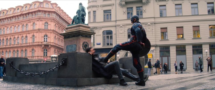 John Walker stands over Nico in the courtyard.