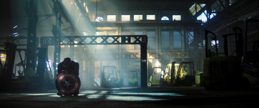 John Walker kneeling in Latvian warehouse.