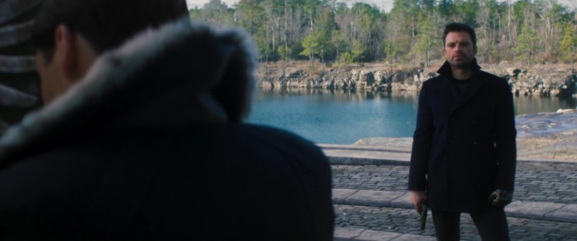 Zemo and Bucky standing in front of Sokovian memorial. 