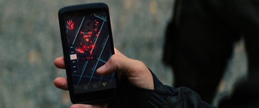 Close up of hand holding phone with the Flag Smasher app open.