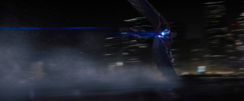 Nighttime shot of helicopter flying low over East River in New York.