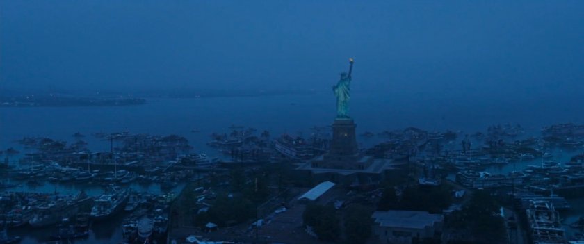Aerial image of Statue of Liberty with hundreds of boats parked around the island.