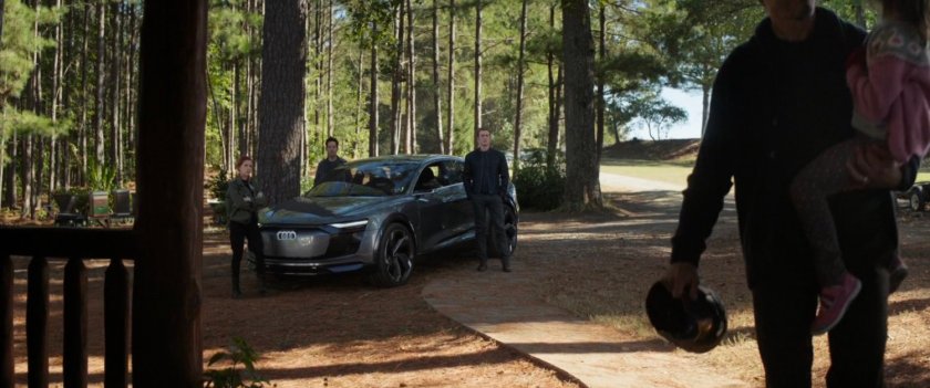 Natasha, Scott and Steve stand by a car in the woods.
