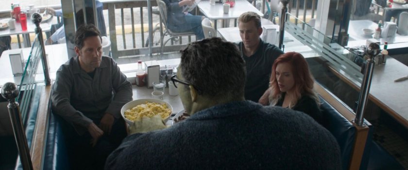 Smart Hulk with a few other Avengers in a small diner.