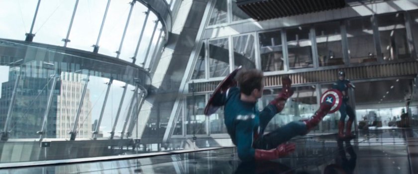 Captain America falling on his ass in a modern office building setting.