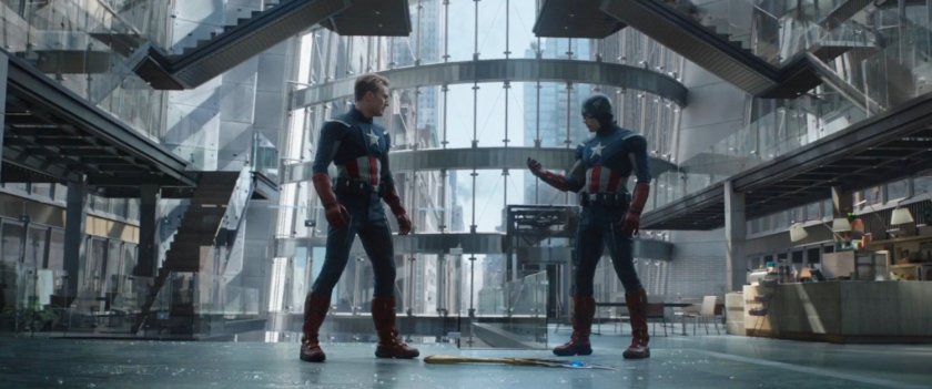 Captain America confronting Captain America in a glass and steel office building.