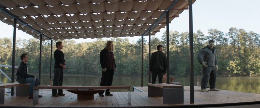 The Avengers on a dock on the river.