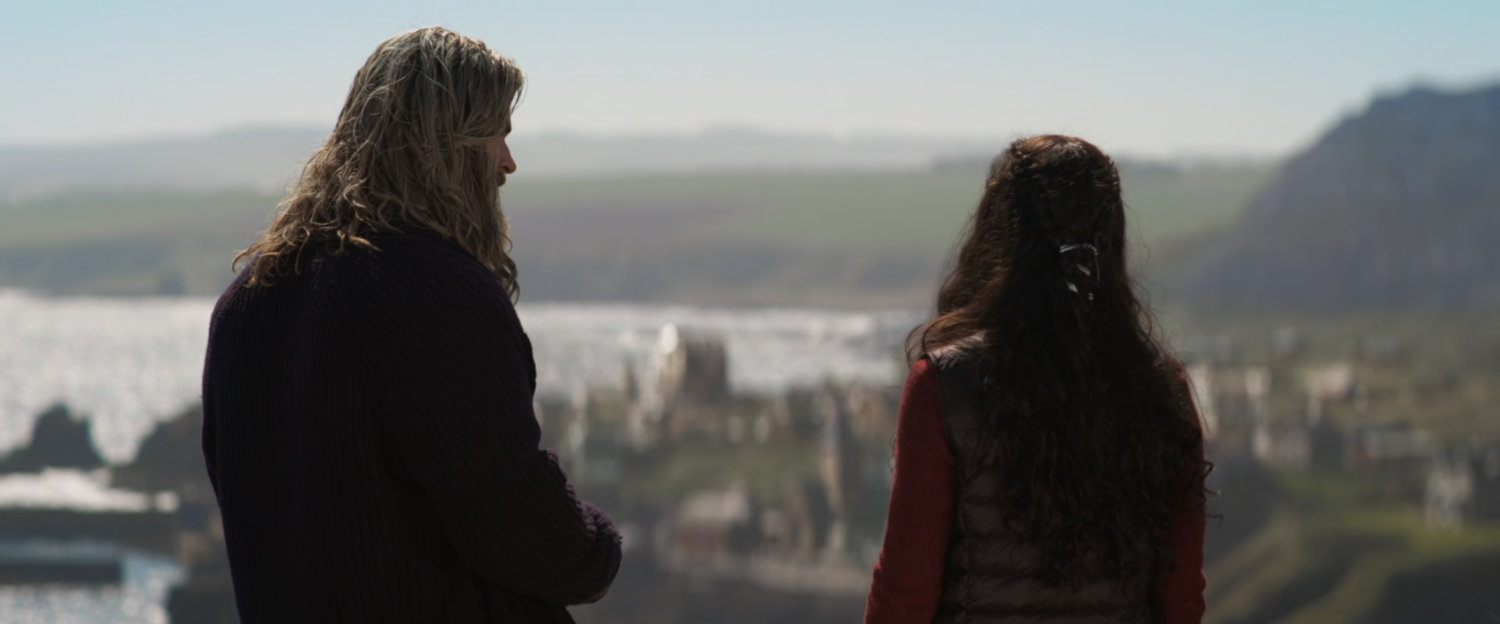 Valkyrie and Thor look down from atop a hill into New Asgard.