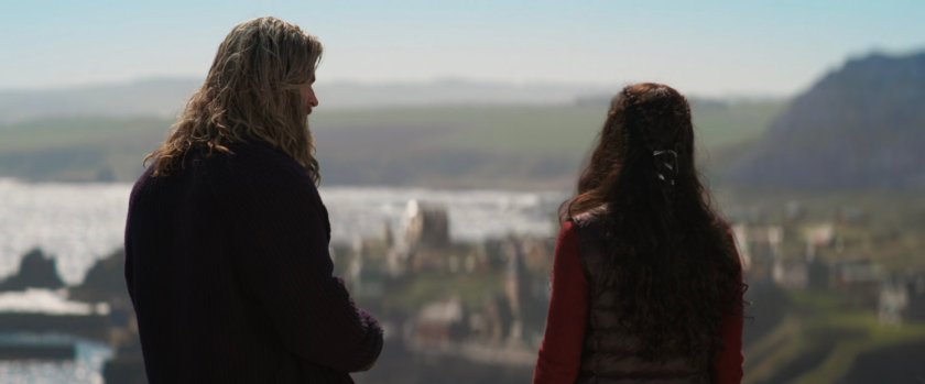 Valkyrie and Thor look down from atop a hill into New Asgard.