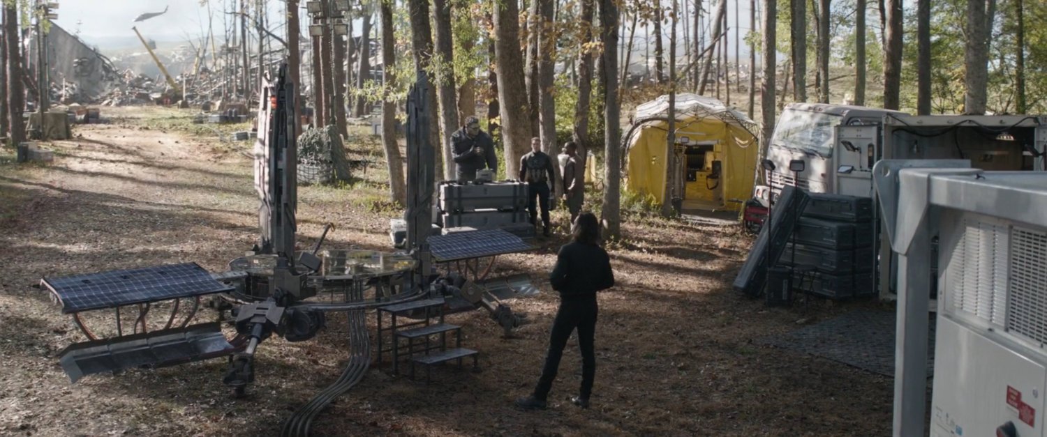 A time portal and campers in a wooded clearing.