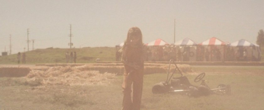 Young Carol Danvers brushes the dust off herself after a go cart crash.