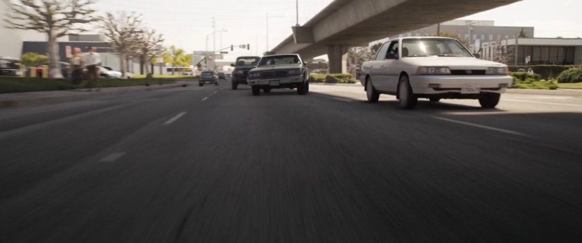 Nick Fury's car racing along a Los Angeles street.
