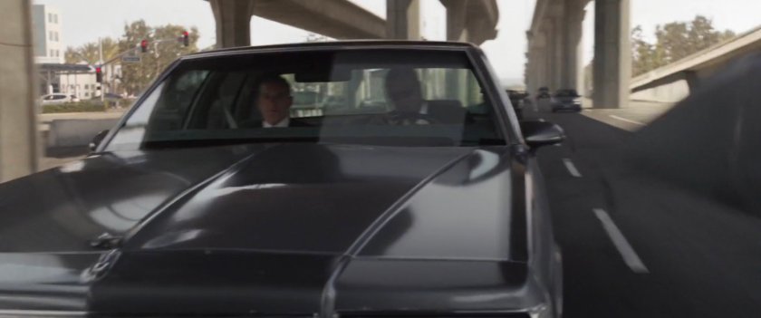 Fury and Coulson in car driving under Metro overpass.