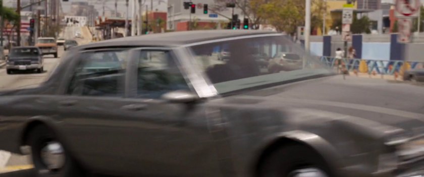 Nick Fury swerves car across train tracks.