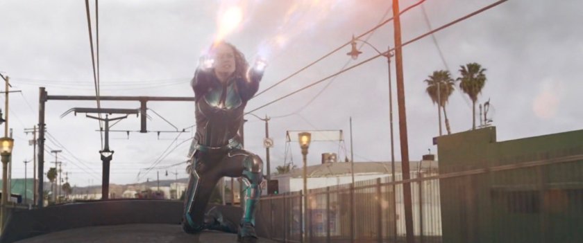 Vers, sitting on top of Metro train, blasts energy from her hands.