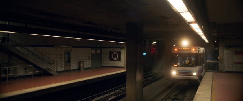 A metro train pulls into an underground station.