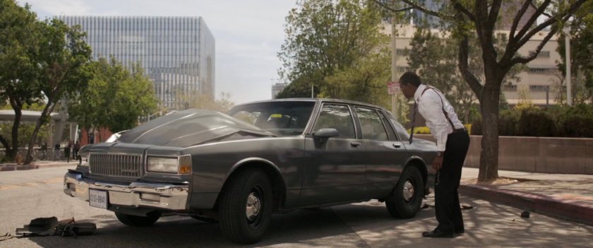 Nick Fury staring at his car stopped in middle of Los Angeles street.