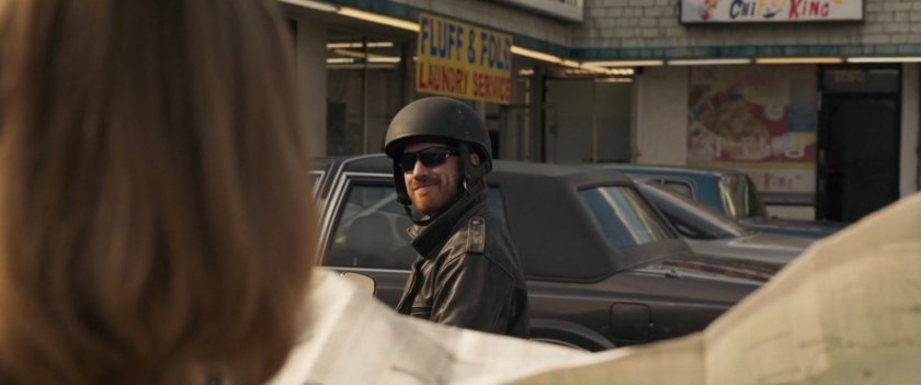 Man on motorcycle smiles at Vers.