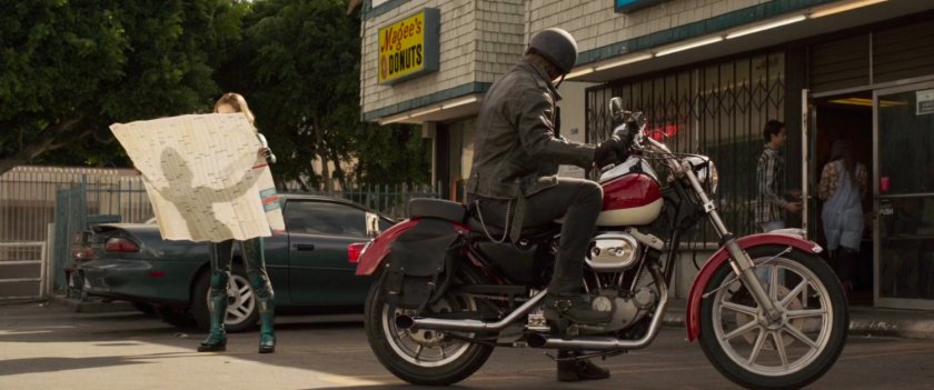 Vers with map outside small strip mall with Internet cafe.