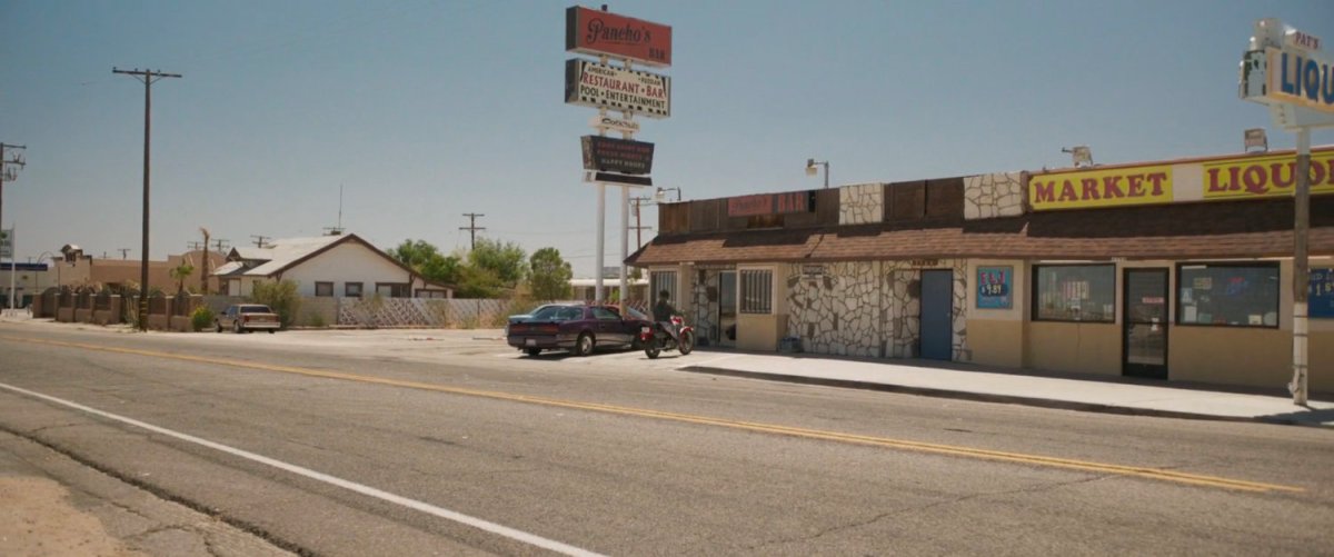 Vers pulls up outside Pancho's Bar on a motorcycle.