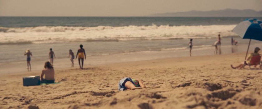 Children frolic in the surf at a beach.