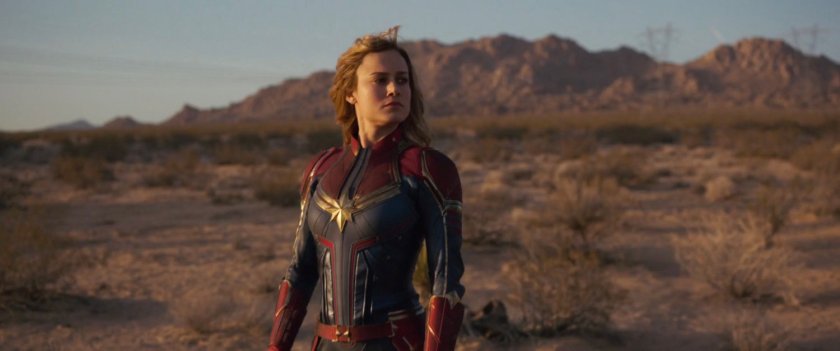 Captain Marvel standing proudly in the desert.