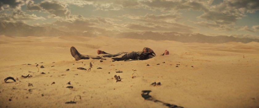 Loki lying in sand of Gobi Desert.