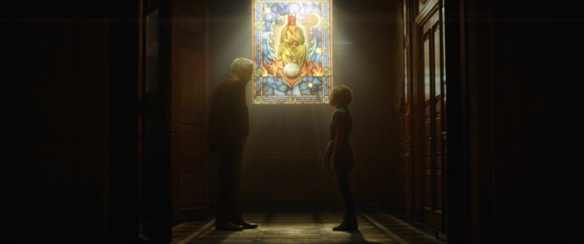 Mobius speaks to young boy by stained glass window.