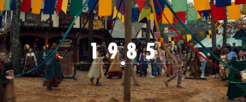 People dancing around may pole at Renaissance Faire. Text: 1985.
