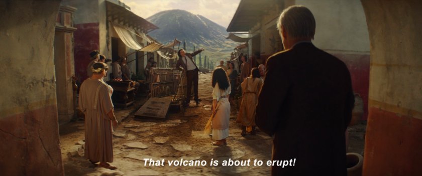 Loki standing on a cart warning citizens of Pompeii about volcano.