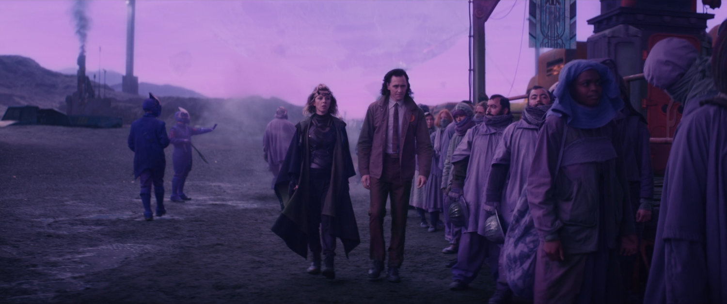 Loki and Sylvie walk past train boarding line on Lamentis-1.