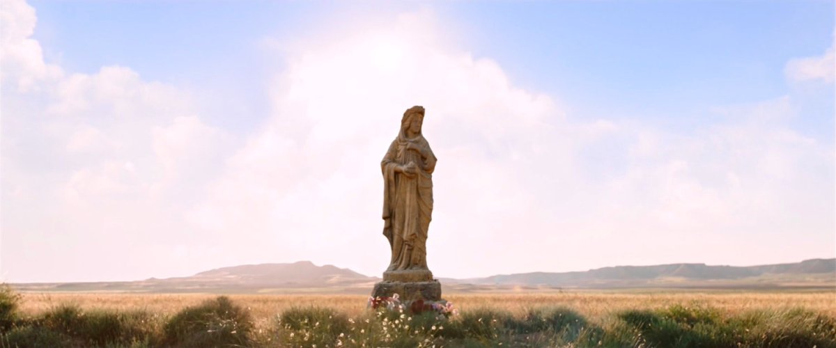 Statue in the middle of a large dry plain.