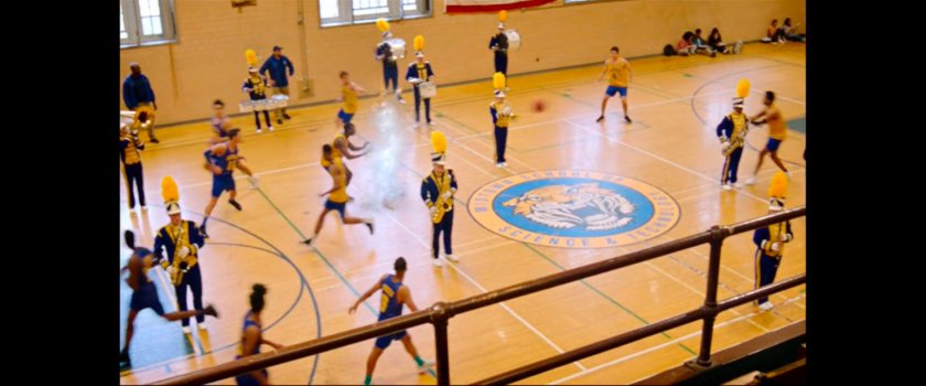 Members of the marching band reappear during basketball game inside the Midtown High gymnasium.