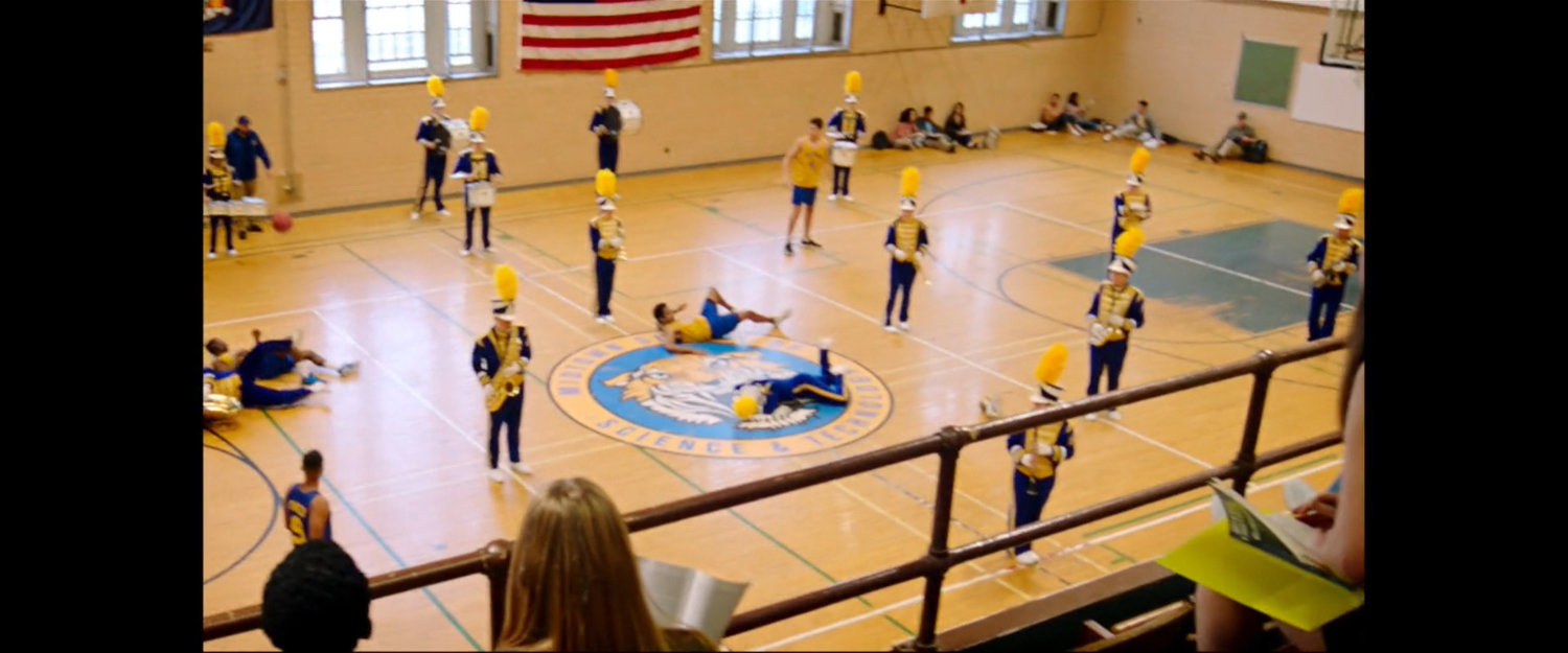 Members of the marching band reappear during basketball game inside the Midtown High gymnasium.