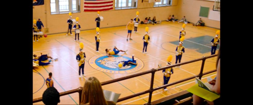 Members of the marching band reappear during basketball game inside the Midtown High gymnasium.